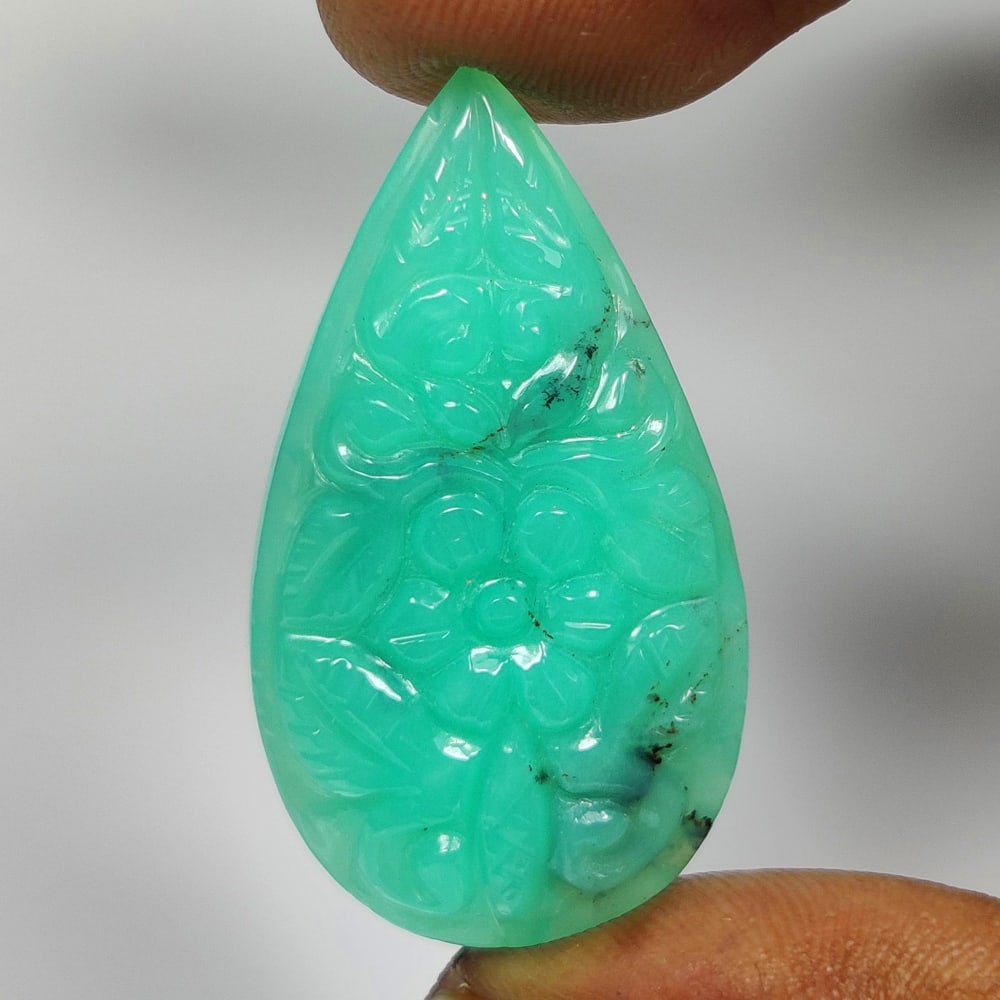 26.74 Ct Natural Green Chrysoprase Pear Carving Cab: Weight - 26.74 Ct / Size - 36.00 x 19.20 x 6.40 mm / Shape - Pear Carving Cab / Clarity - Opaque / Origin - Brazil / Treatment - None