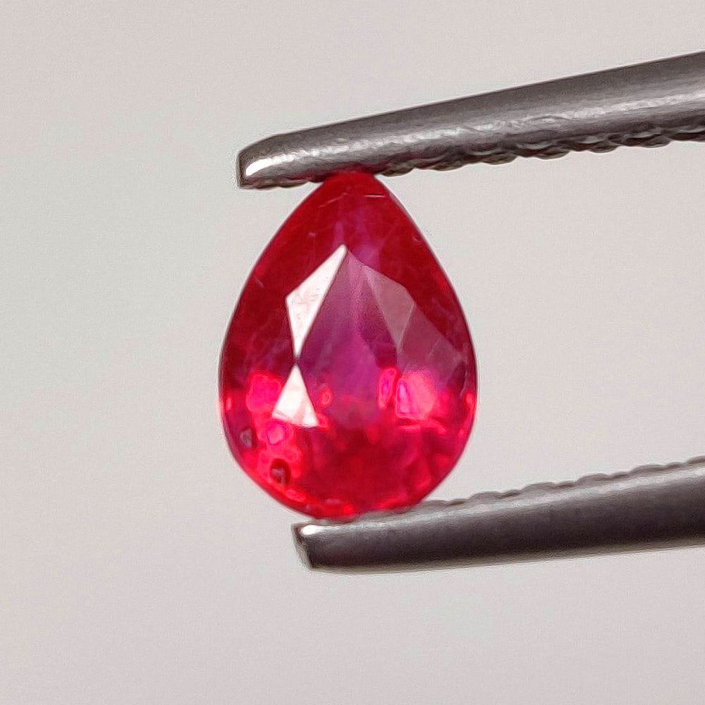 0.52 Ct Natural Pinkish Red Ruby Pear Cut: Weight - 0.52 Ct / Size - 5.70 x 4.10 x 2.70 mm / Shape - Pear Cut / Color - Pinkish Red / Clarity - SI / Origin - Mozambique / Treatment - Heated With Glass Filling
