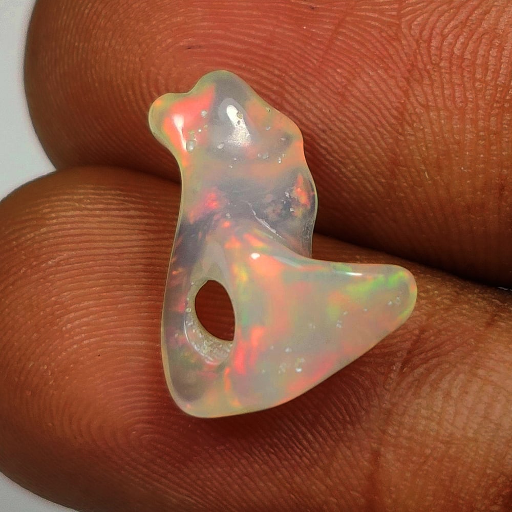 2.20 Ct Natural Multicolor Welo Opal Top Fire Drilled Solid Rough: Weight - 2.20 Ct / Size - 14.70 x 10.60 x 6.40 mm / Shape - Solid Rough Cab / Color - Multicolor / Clarity - Translucent / Origin - Ethiopia / Treatment - None