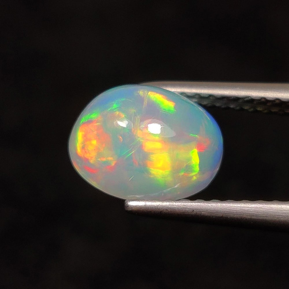 1.51 Ct Natural Multicolor Welo Opal Fire Oval Cab: Weight - 1.51 Ct / Dimensions - 9.00 x 7.00 x 4.90 mm / Shape & Cut - Oval Cab / Color - Multicolor / Transparency - Translucent / Origin - Ethiopia / Comments - None