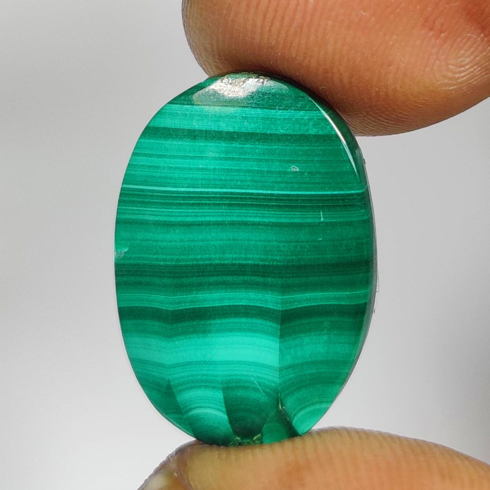 14.85 Ct Natural Green Malachite Oval Cab: Weight - 14.85 Ct / Dimensions - 19.70 x 13.70 x 4.00 mm / Shape - Oval Cab / Color - Green / Clarity - Opaque / Origin - Russia / Treatment - None