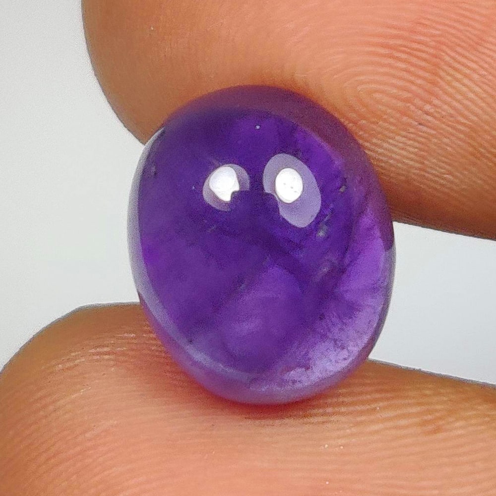 5.24 Ct Natural Purple Amethyst Oval Cab: Weight - 5.24 Ct / Dimensions -12.00 x 10.00 x 5.70 mm / Shape - Oval Cab / Color - Purple / Clarity - VVS / Origin -Brazil / Treatment - Heated