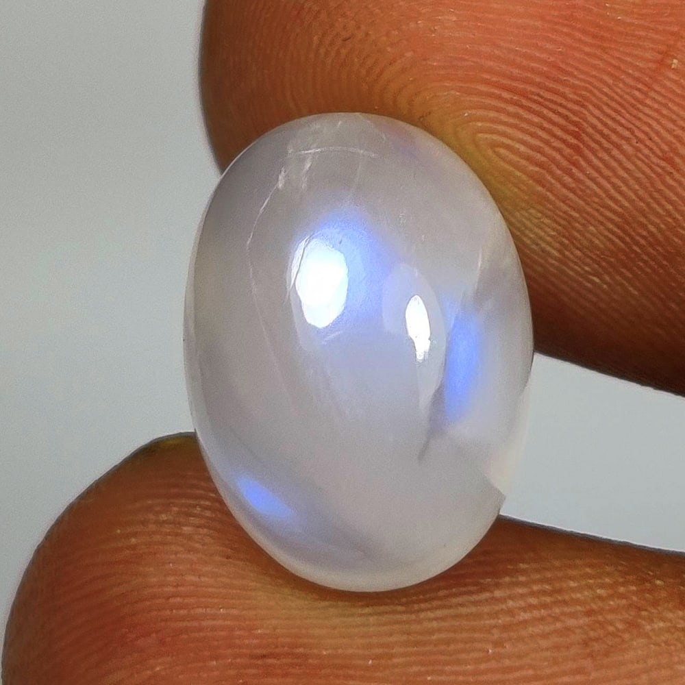 7.22 Ct Natural Blue Tint Moonstone Oval Cab: Weight - 7.22 Ct / Size - 14.00 x 10.10 x 6.60 mm / Shape - Oval Cab / Clarity - Semi Opaque / Origin - India / Treatment - None