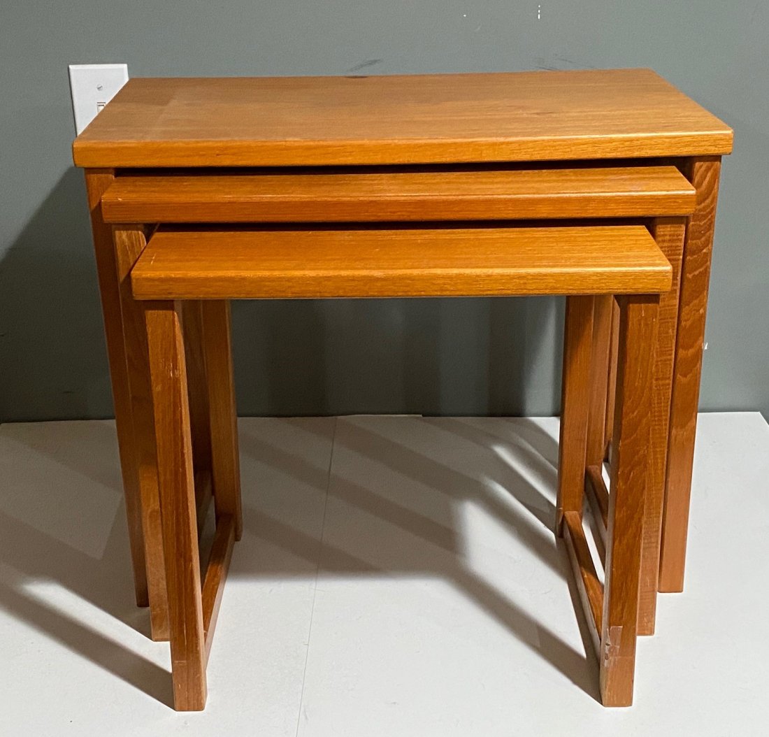 Danish Modern Set of 3 Teak Nesting Tables: Set of 3 teak nesting tables marked Made in Denmark on the bottom. The largest one measures 18.5 inches by 23 inches by 13 inches.