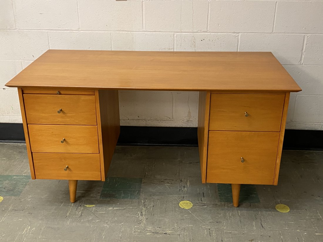 Mid Century Modern Paul McCobb Planner Group Desk: Mid century modern Paul McCobb Planner Group desk with slide out shelf. Brass pulls. The desk measures 53 inches by 26.5 inches by 29 inches tall.