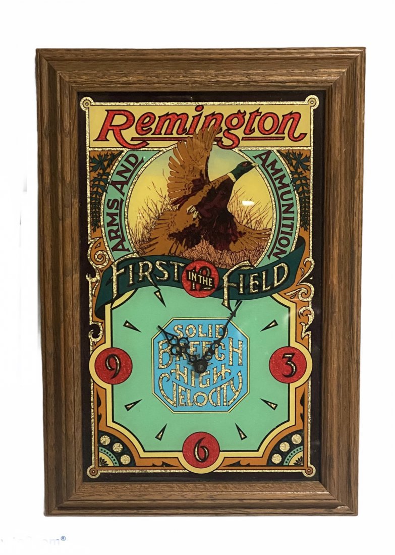 Foil Back Remington Advertising Clock: Foil Back Remington Advertising Clock. It measures 19"TX13"WX2"D.