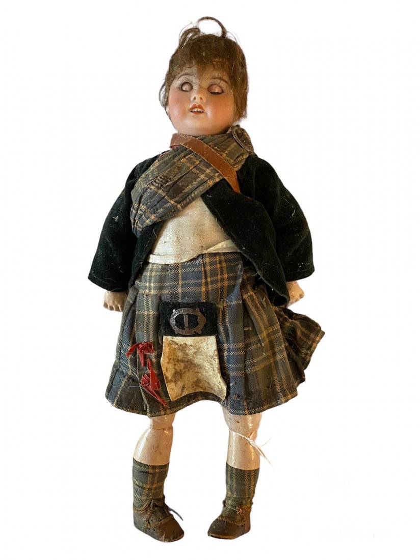 Antique Bisque Head Doll in Antique Scottish Outfit: Antique Bisque head Doll in Antique Scottish Outfit with Kilt. Some Markings on the back of the head. Approximately 15 inches tall.
