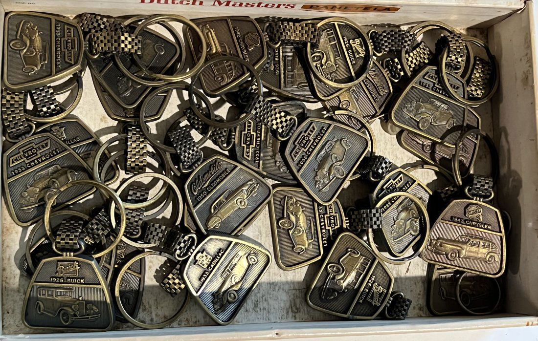 Lot of Vintage New Old Stock Classic Car Keychains: Lot of vintage new old stock classic car metal keychains. Approximately 25 in the lot as pictured.
