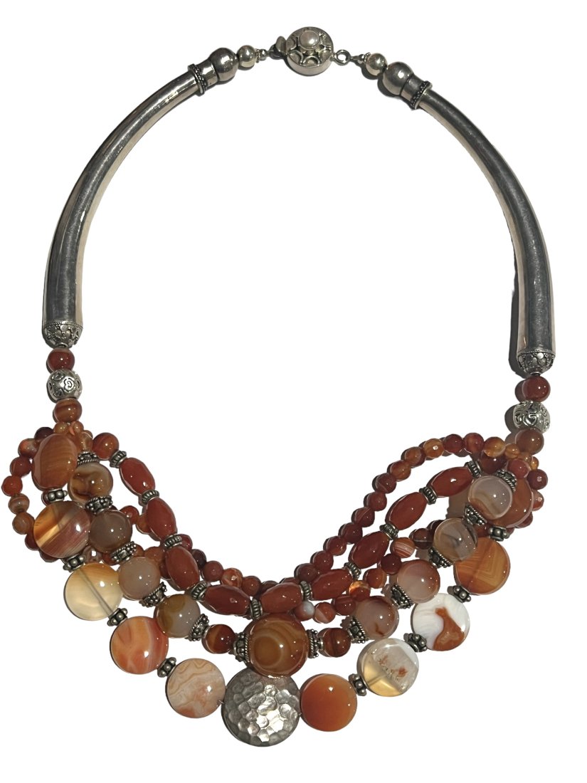 Sterling Silver and Carnelian Necklace: Sterling Silver and Carnelian Necklace. Multi-strands of carnelian carved beads of various shapes. About 20 inches long. Shipping- In addition to LiveShip, Live Auctioneers Shipping), we also offer fl