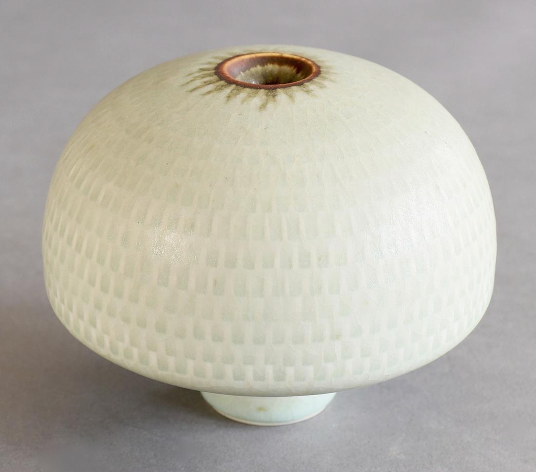 Karl Scheid, Vase, seladon: Karl Scheid, Vase. 1975. Porcelain. Slightly reliefed graphic decor, transparent craquelled celadon-colored glaze. H. 10.5 cm. Inscribed with workshop mark on the bottom and dated 75 (embossed stamp).