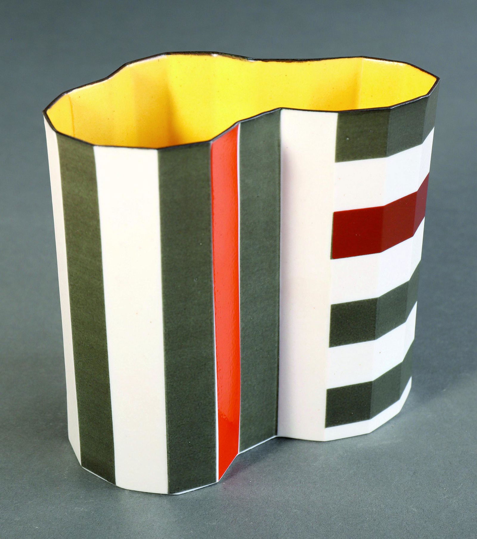 Bodil Manz, Vase: Bodil Manz, Vase. Porcelain. Decor with vertical and horizontal stripes in orange, rust red and olive gray. Inside wall in yellow. 13.2 x 14 x 9 cm. Marked on the bottom with workshop mark (painted bl