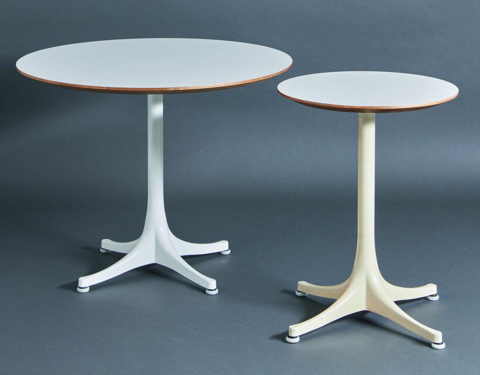 George Nelson, 2 Occasional Tables Mod. 5451 / 5452: George Nelson, (1908-1986), Vitra, Weil am Rhein, 2 side tables model 5451 / 5452. Designed in 1953. White coated cast aluminum, white coated plywood. H. 57 x D. 72,5/43 cm.
