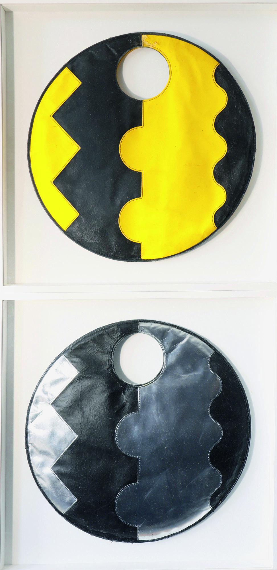 Alessandro Mendini, Alchimia, 2 Handbags / Bags: Alessandro Mendini, Alchimia, 2 handbags. Designed in 1987. Synthetic leather in black / silver and black / yellow. D. 44 cm. The two objects are each in a white painted wooden frame. 55 x 55 x 5 cm.