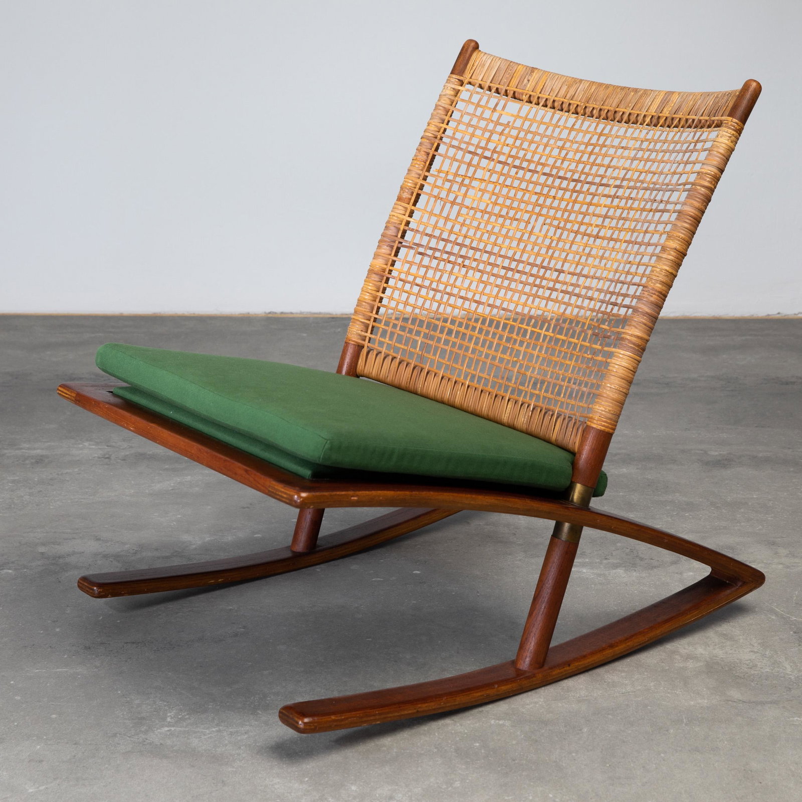 Fredrik A. Kayser Vatne Rocking Chair Model 599: Fredrik A. Kayser, Vatne Stolefabrik, Rocking chair model 599. Designed around 1958. Teak, wicker, brass green fabric. 78 x 59 x 79 cm.