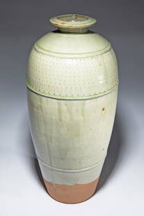 Richard Batterham, Large floor Vase: Richard Batterham Large floor vase. Stoneware. Glossy celadon-colored glaze, partially mottled with brown. Elongated ovoid shape, and profile rings on the shoulder, the intermediate area notched. H. 5