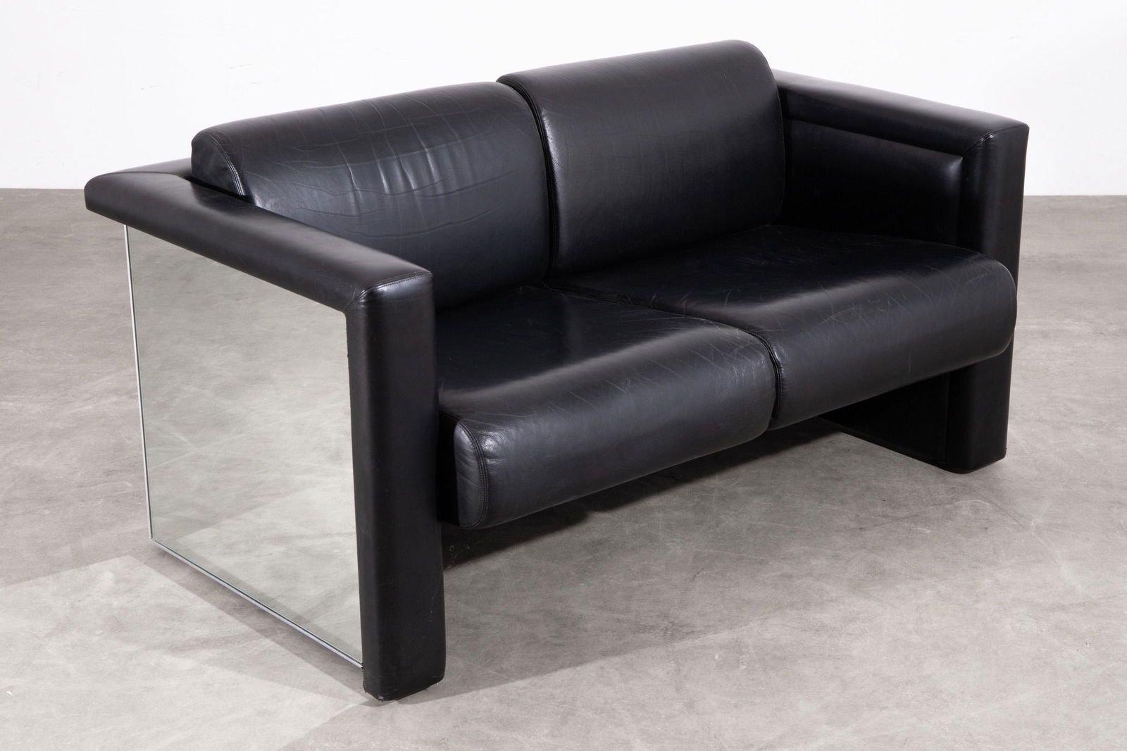 Trix & Robert Haussmann, Knoll International, Mirror Sofa Model 57S2: Trix & Robert Haussmann Knoll International Sofa model 57S2. Designed 1988. Black leather, mirror glass. 74 x 139 x 86. Inscribed 'Knoll' on the underside. Literature: Knoll International, Produktkata
