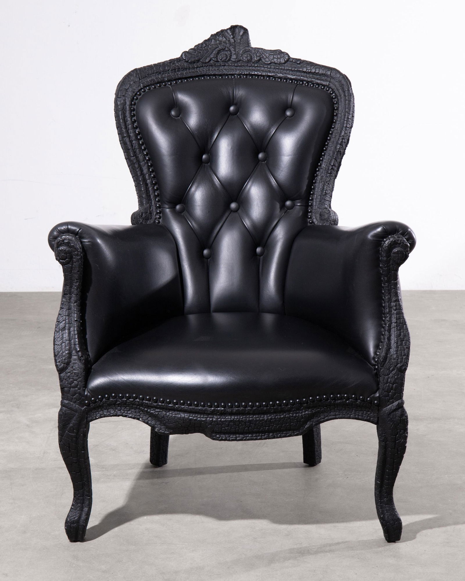 Maarten Baas, Moooi, Unique Lounge Chair model Smoke Armchair: Maarten Baas Moooi Unique lounge chair, model Smoke Armchair. Designed 2002. Burnt wood preserved with epoxy resin, black leather. 103 x 75 x 74 cm. Inscribed with 'Moooi' metal plaque. Because the ar