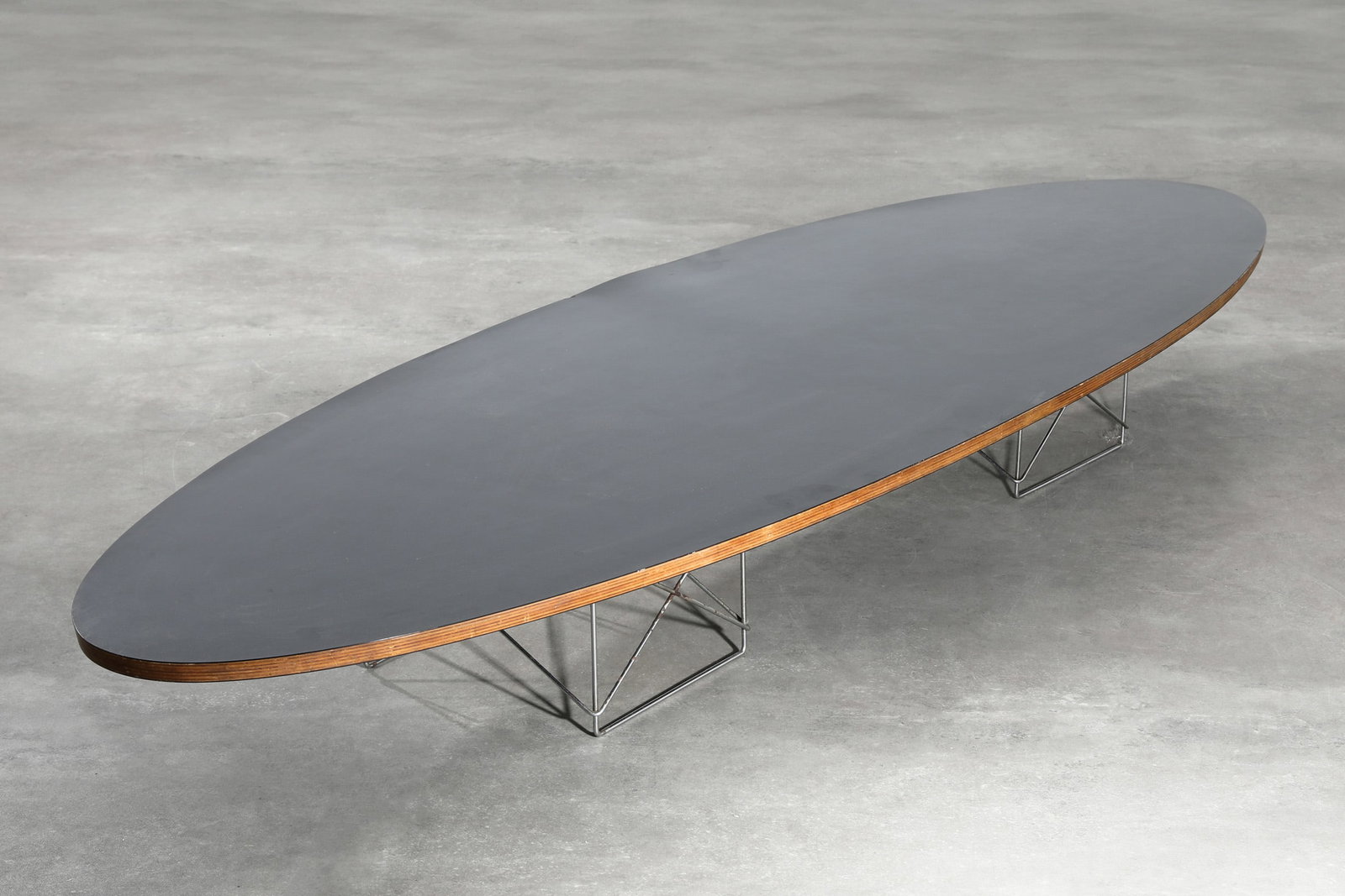Charles & Ray Eames, Herman Miller, coffee Table, model ETR Surfboard Table: Charles & Ray Eames Herman Miller Coffee table, model ETR Surfboard Table. Designed in 1951. Black laminated plywood, chrome-plated steel wire. 26 x 224 x 74 cm. Inscribed with 'Herman Miller' plaque.