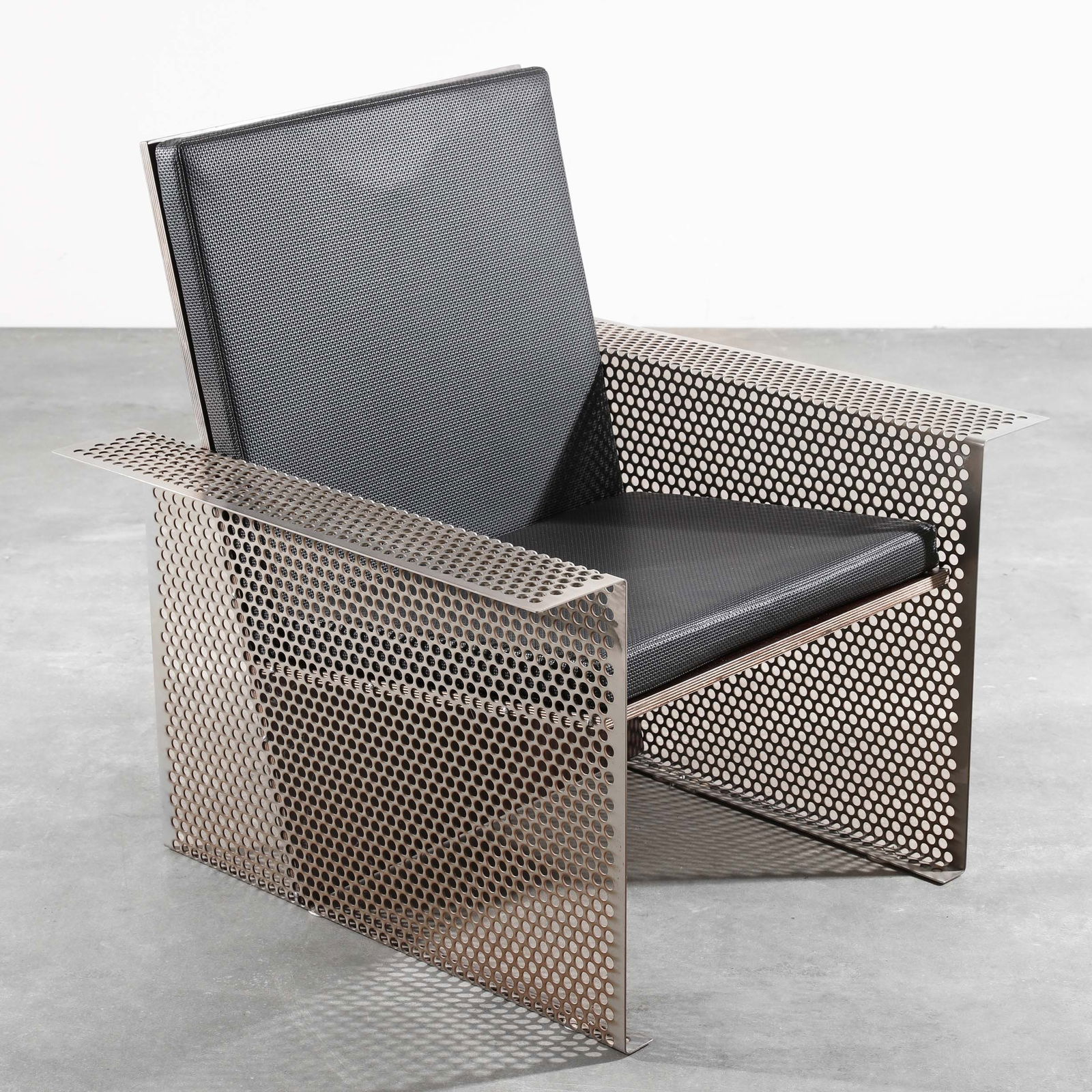 Hermann Waldenburg, Armchair, model Qubus: Hermann Waldenburg Armchair, model Qubus. Designed in 1987. Perforated sheet steel, wood, artificial leather, 82 x 80 x 70 cm. Signed on all four corners of the armrests with an incised 'W'. According