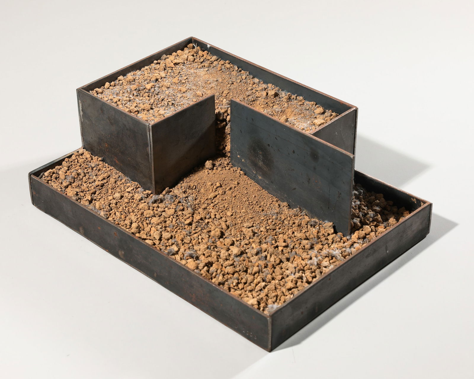 Madeleine Dietz, Sculpture, iron + gravel, 2003: Madeleine Dietz Untitled. 2003. Steel body on two levels, filled with gravel. 30.5 x 22 x 10 cm. Monogrammed and dated on the front right: M.D. 2003 (impact stamp).