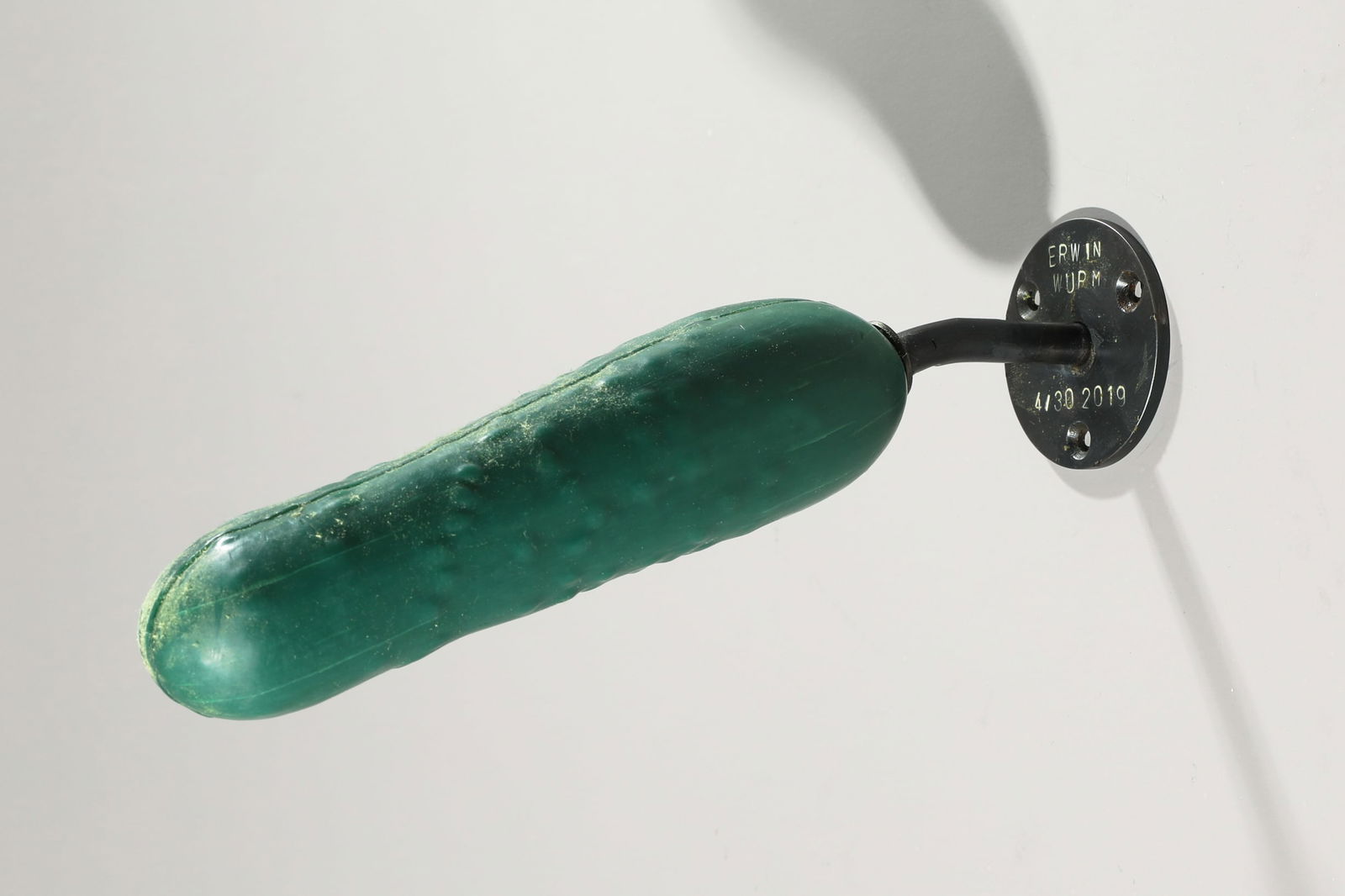 Erwin Wurm*, Untitled, 2019, Sculpture cucumber, soap: Erwin Wurm*, (*1954) Untitled. 2015. Sculpture made of green soap, in the shape of a cucumber, mounted on a metal wall mount. L. 25 cm, D. 5 cm. Here number 4 from an edition of 30 copies. Marked, num