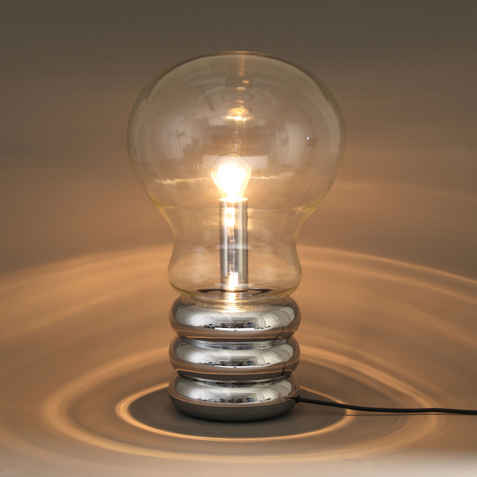 Ingo Maurer, Large floor or table lamp model Giant Bulb: Ingo Maurer Designed in 1966. Production Design M. Chrome-plated metal and clear glass. H. 54, D. 32 cm. Marked with company sticker. Helmut Bauer, Ingo Maurer: Making Light, München1992, Abb. S.