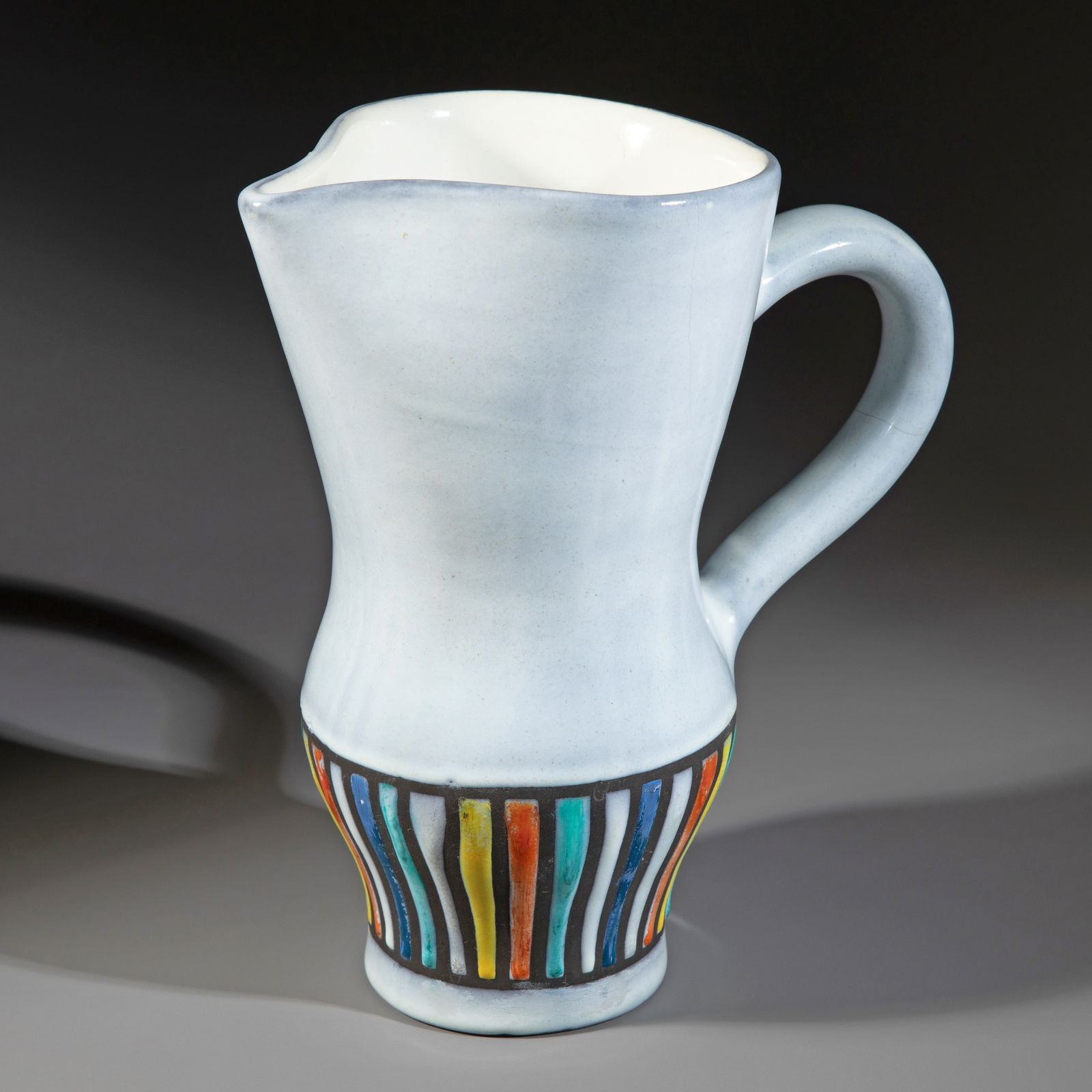 Roger Capron, Jug: Ceramic. Bluish glaze. The lower part of the wall features polychrome striped decoration. 25 x 22 x 14 cm. Inscribed on the underside: CAPRON, VALLAURIS.