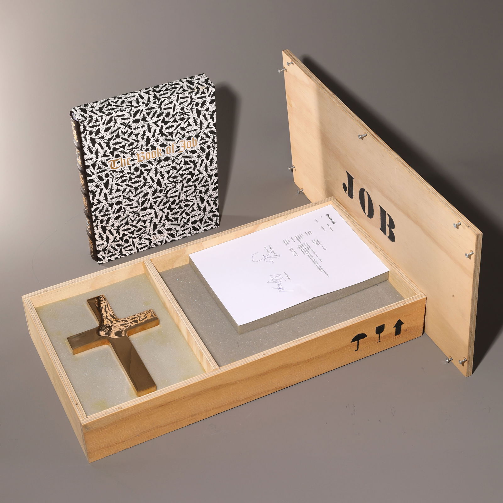 Studio Job, The Book of JOB, 2010: Book and cross made of polished bronze in a wooden box. 33 x 26 x 4.5 cm (book) / 24 x 15.4 x 1.5 cm (cross) / 32 x 61.5 cm x 11 cm (box). Number 11 from a small edition of 25 + 4 AP copies. STUDIO JO