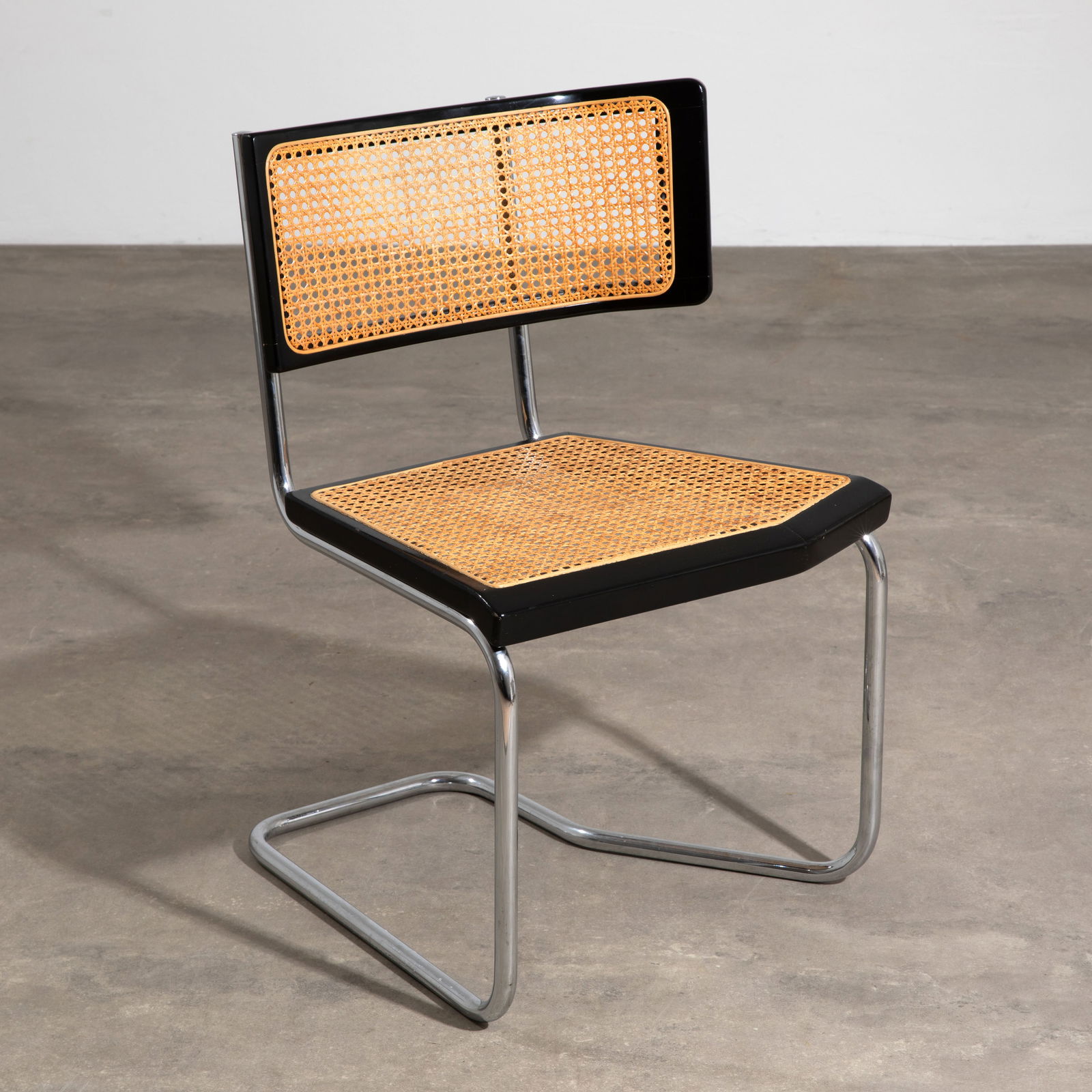 Stefan Wewerka, Rare cantilever chair model B2: Designed in 1980. Manufactured by Tecta, Lauenförde. Chrome-plated tubular steel, black lacquered wood, and Viennese wickerwork. 82 x 53 x 51 cm.