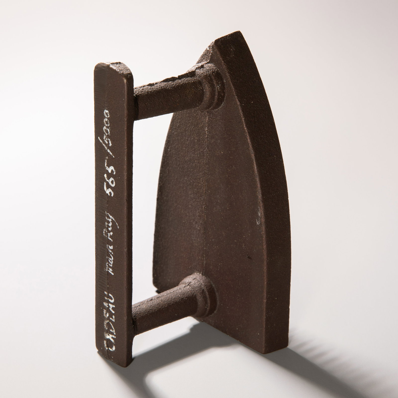 Man Ray (1890-1976), 'Gift', 1921/1974: Man Ray Cast iron with mounted copper nails. 16.5 x 10 x 8 cm. Inscribed, signed, and numbered in white on the handle: CADEAU Man Ray 565/5000. Also inscribed, monogrammed, and numbered in felt-tip pe