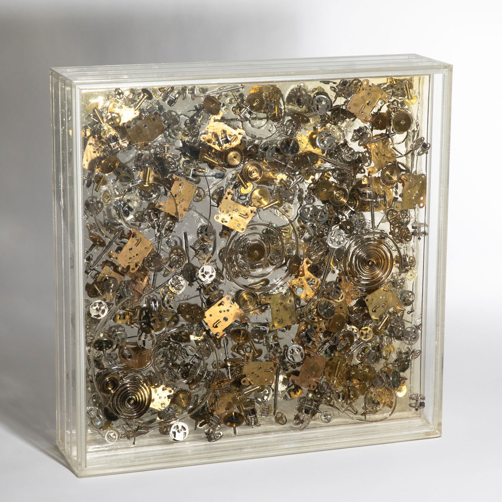 Armand Fernandez (Arman) (1928 Nice-2005 New York), 'Les Rouages du Temps II', 1975: Fernandez (Arman), Armand Assemblage. 11 x 46 x 46 cm. Parts of clockworks cast in Plexiglas, mounted one behind the other in various layers. Signed lower right: arman. Inscribed (scratched) lower lef