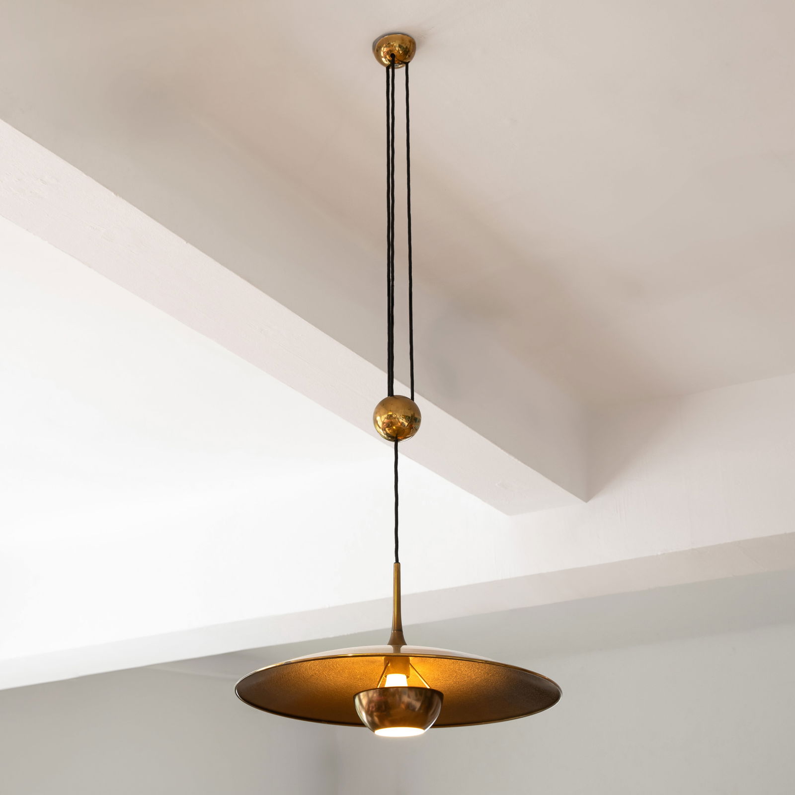 Florian Schulz, Pendant light model Onos 55: Florian Schulz Designed in the 1960s/70s. Manufactured by Florian Schulz GmbH. Brass with a burnished underside, black fabric cable. Reflector dimensions: H. 30 cm, D. 55 cm.