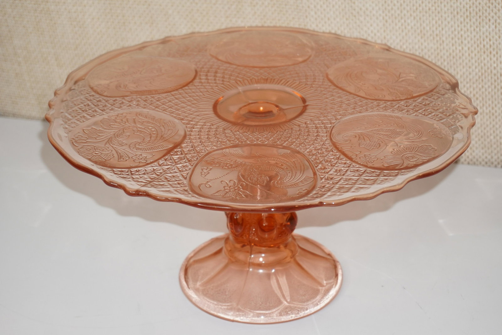 PINK DEPRESSION GLASS CAKE STAND: PINK DEPRESSION GLASS CAKE STAND, 6"H X 12.5"W, VERY GOOD CONDITION