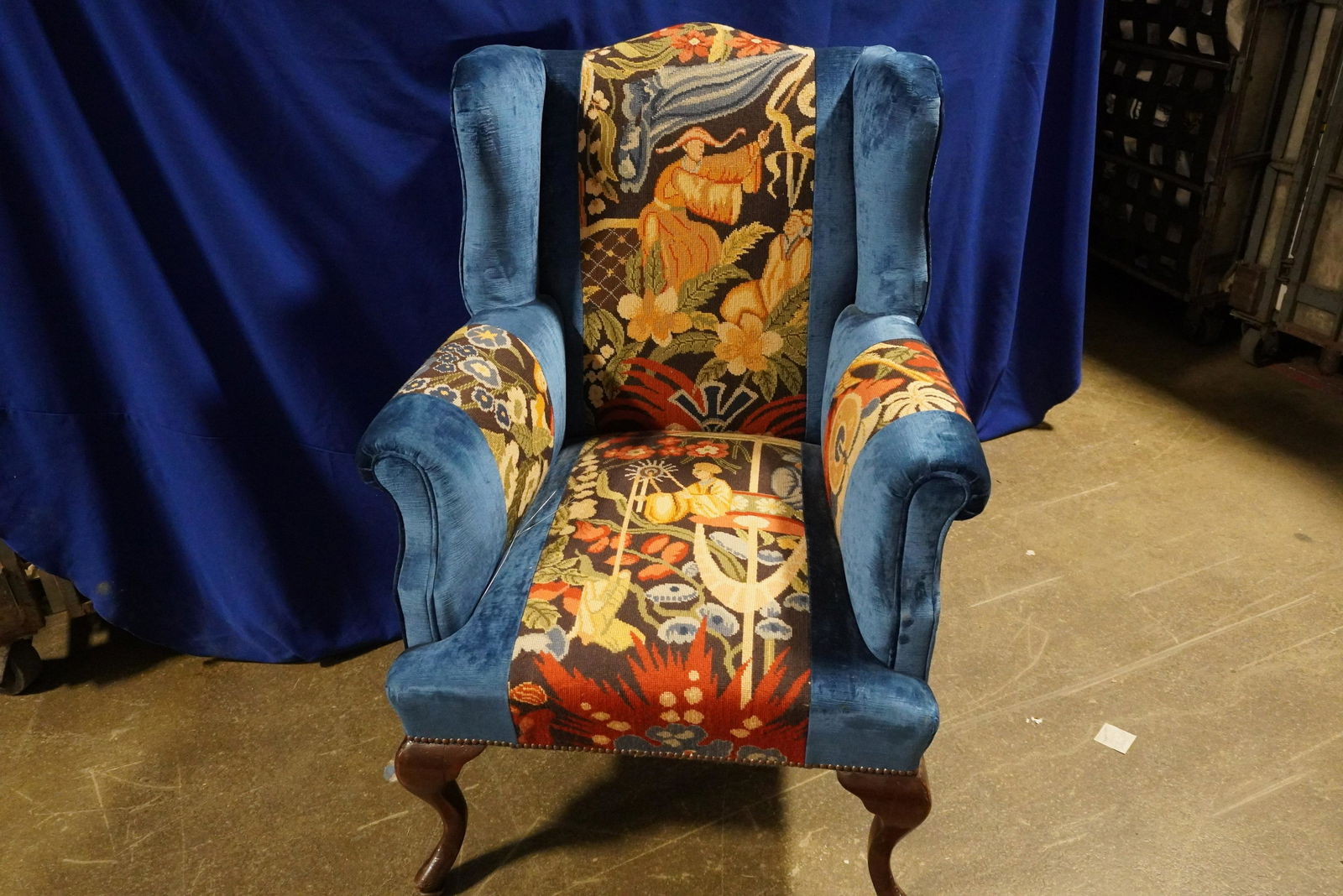 BLUE VELVET & NEEDLEPOINT WINGBACK CHAIR: BLUE VELVET & NEEDLEPOINT W/ NAILHEAD DETAIL ON MAHOGANY LEGS WINGBACK CHAIR