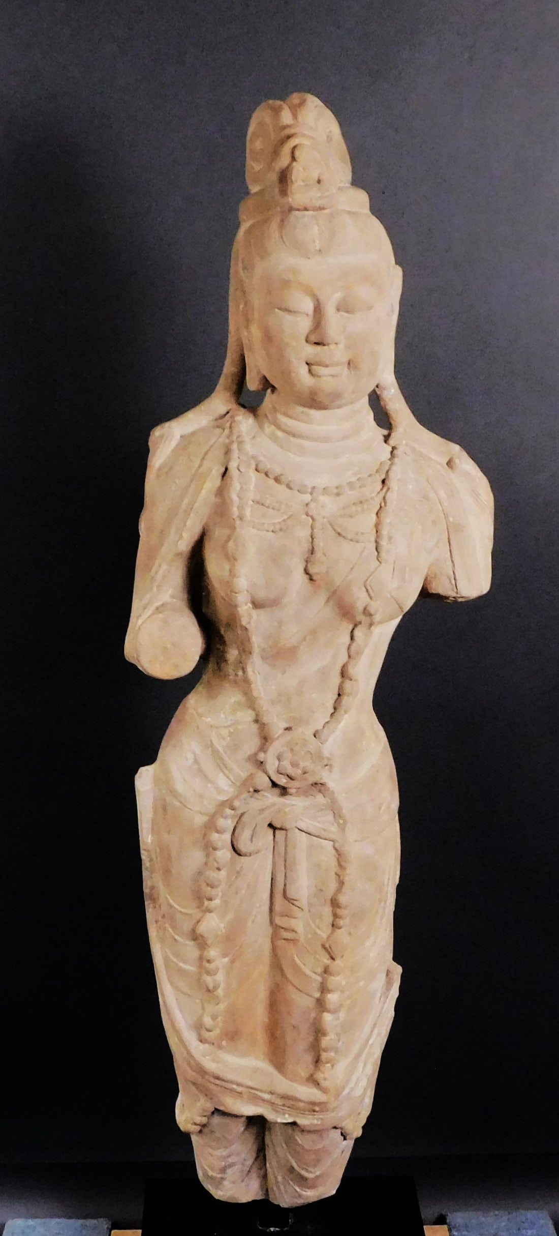 Carved Stone Guan-yin Tang Dynasty: Carved Stone Guan-yin presumably Tang Dynasty (618-907) traces of pigment, pole mounted Approx. 52 x 16 x 8" (Overall 57.5" with base) PROVENANCE: Weisbrod Chinese Art, Ltd., New York