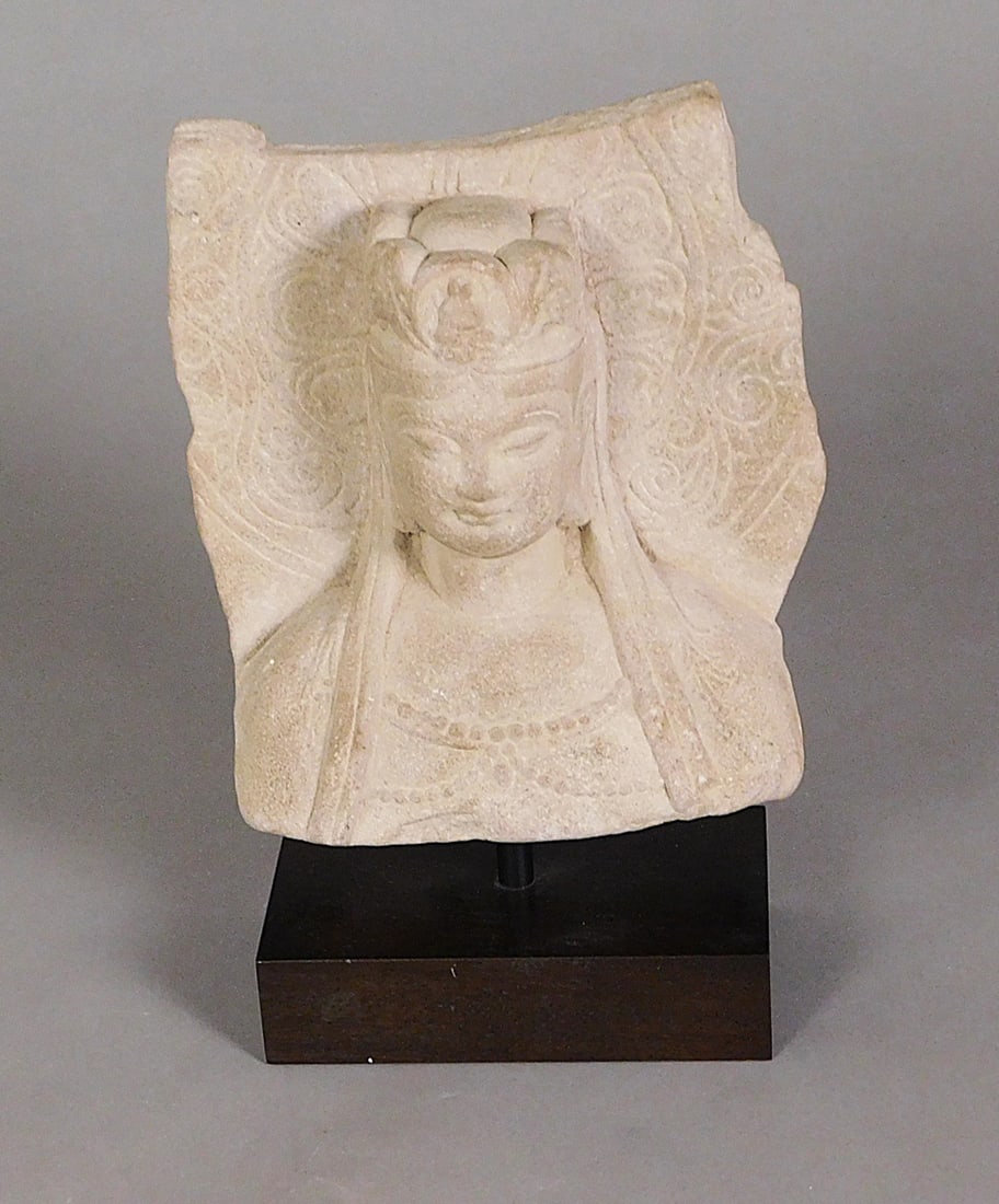 Carved Sandstone Guanyin Head & Shoulders Northern Qi: Carved Sandstone Guanyin Head & Shoulders pole mounted on a plinth presumably Northern Qi Dynasty (550-577) Approx. 9.5 x 8 x 3" PROVENANCE: Weisbrod Chinese Art, Ltd., New York