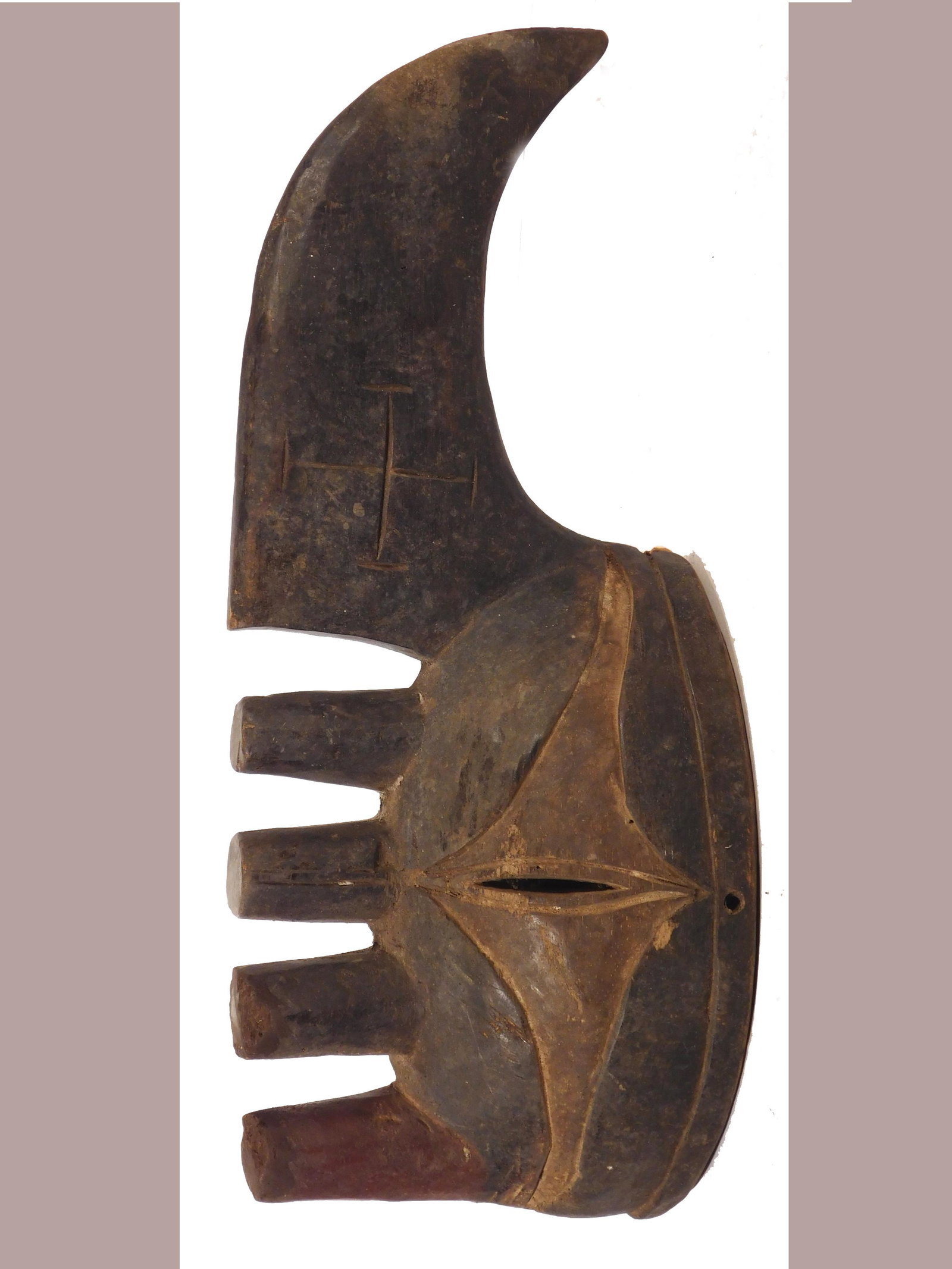 Yam Knife Mask, Igbo Afikpo, Nigeria: African Tribal Art: Igbo Afikpo People, Nigeria: Yam Festival Mask, 19th Century. Carved wood with dark stain and traces of kaolin pigment. The form of the mask is inspired by the knives used to cut y