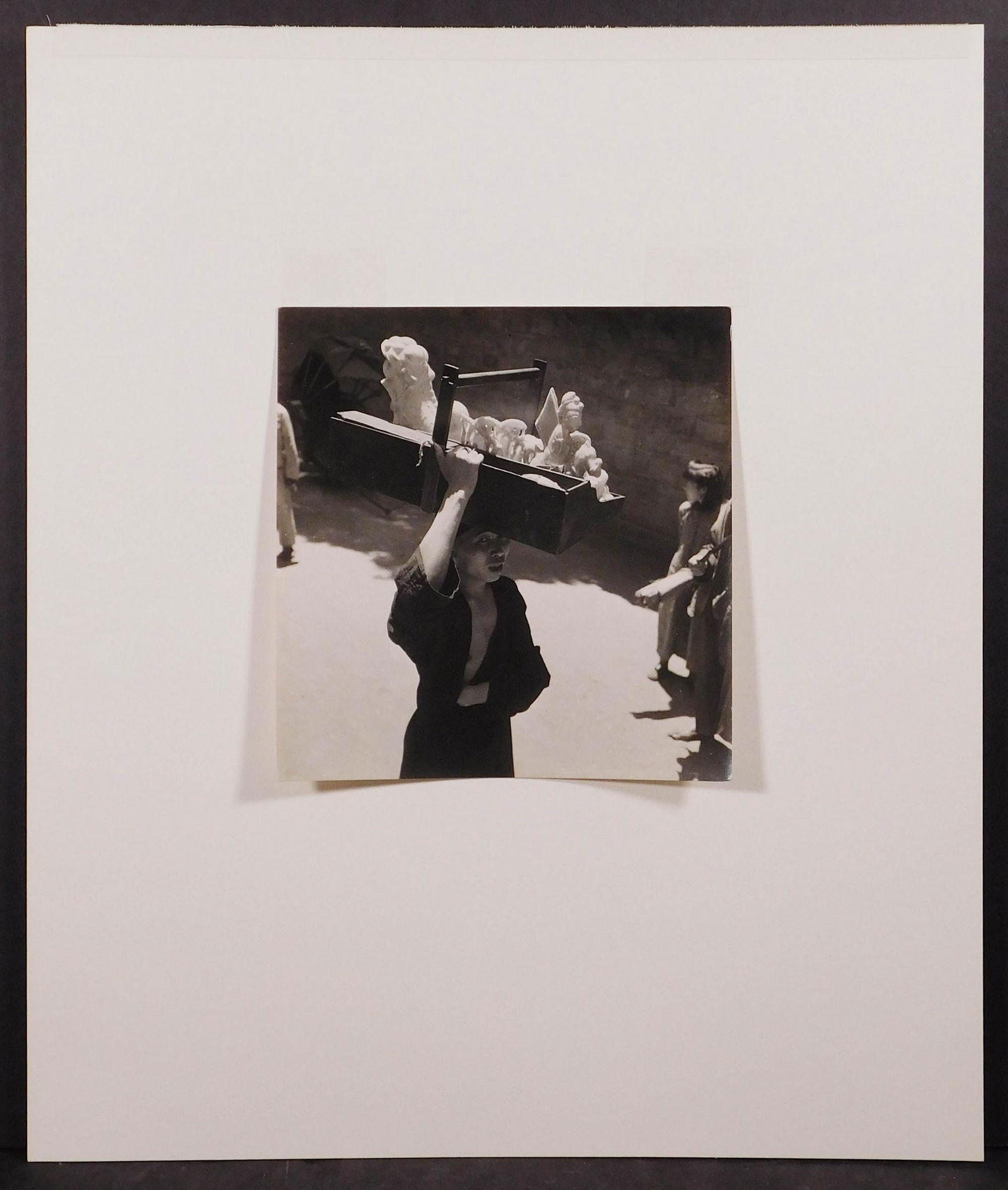 Cecil Beaton: Chinese Sweetseller with Sugar Sculptures, 1945: Cecil Beaton (British, 1904-1980): Chinese Sweetseller with Sugar Sculptures, 1945. Vintage gelatin silver print. Photographed in Chengtu, Sze-chwan, China. Hinged to mat board. Labeled British Offici