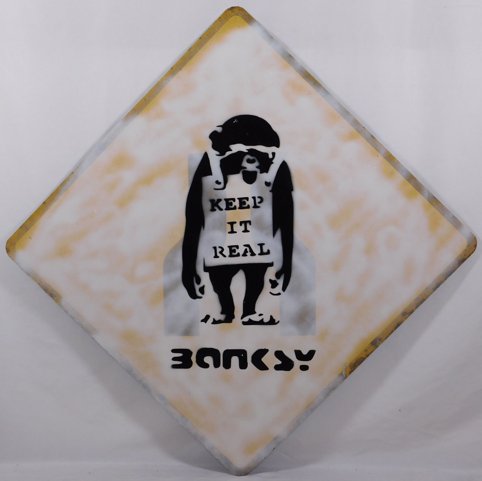 Keep it Real: Keep it Real: This unique painting is a one-of-a-kind piece of British Street Sign Art from the 20th century. The artist has used spray paint on a metal street sign to create a striking and edgy work