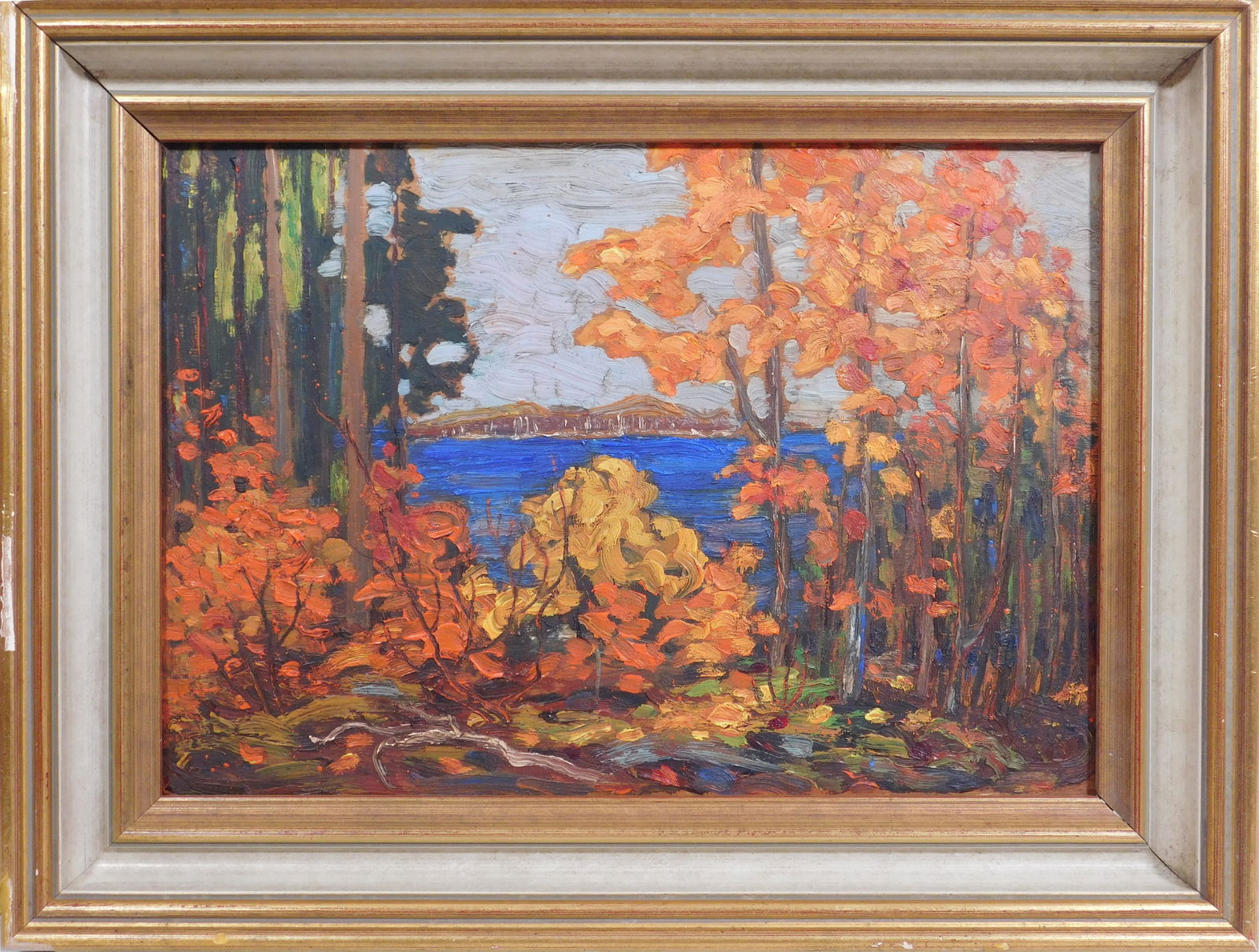 Tom Thomson, Attributed/Manner of: Algonquin Park c.1915: Thomas John "Tom" Thomson (Canadian, 1877-1917) Attributed/Manner of: Algonquin Park c.1915. Oil on wood panel.Bearing the impression of the artist's round logo stamp in the lower right corner .