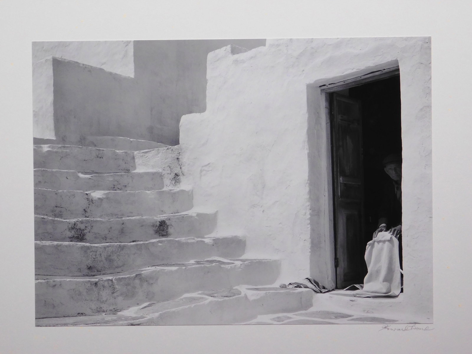 Howard Bond: Man in Doorway, Siphnos: Howard Bond (American, b. 1931): Man in Doorway, Siphnos. Silver gelatin print mounted to rag board, from portfolio VI Greek Islands, 1985, signed in pencil below. Edition 10 of 18. Howard Bond was a 