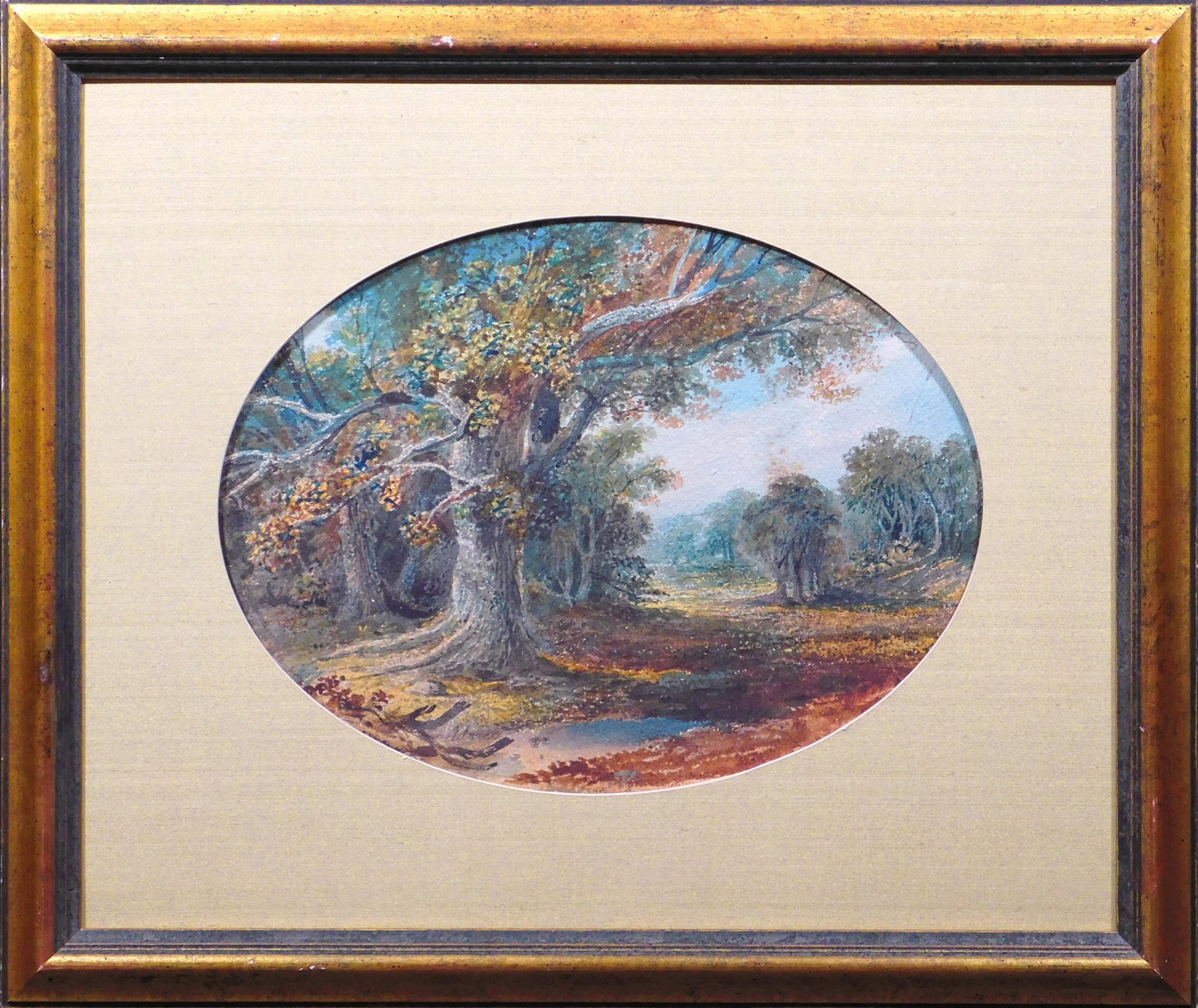 George Inness, Attributed: Autumn Landscape.: George Inness (American, 1825 - 1894) Attributed: Autumn Landscape. Watercolor on oval shaped coldpressed paper mounted to mat board, signend lower left, framed. Born on a farm near Newburgh, New York