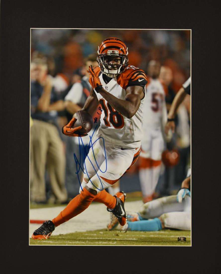 Signed Bengals AJ Green Fuji Crystal Matted Photo: An autographed fuji crystal photograph. This piece features an image and signature of Bengals receiver AJ Green. Green was selected by the Bengals in the 2011 NFL Draft. In his first season, he made t