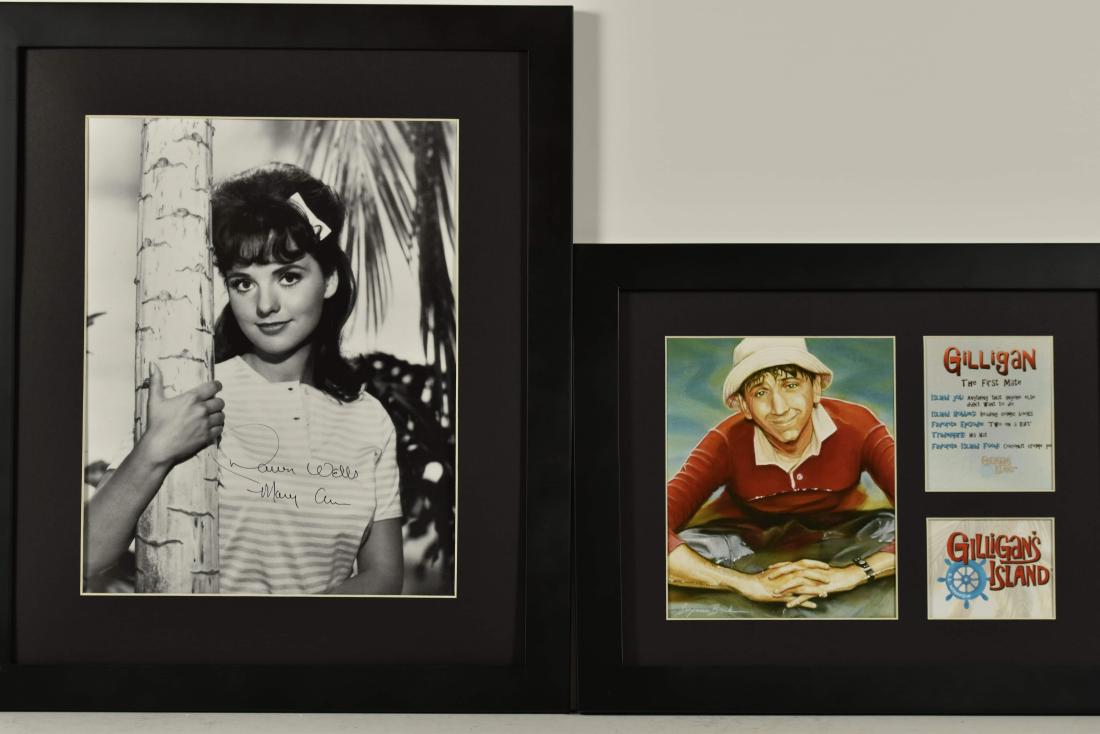 2 Gilligan's Island-Signed Dawn Wells&Gilligan: A pair of Gilligan framed lithographs. The first features Dawn Wells signed Mary Anne themed _Gilligan's Island_ lithographs. The set features an unframed black and white image of Mary Anne hugging a 