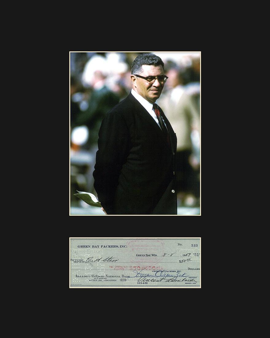 Vince Lombardi with Reproduction Check: An archival photograph entitled "Vince Lombardi." Lombardi is best known as the head coach of the Green Bay Packers during the 1960's. Includes a reproduction of a personal check signed by Vince Lomba
