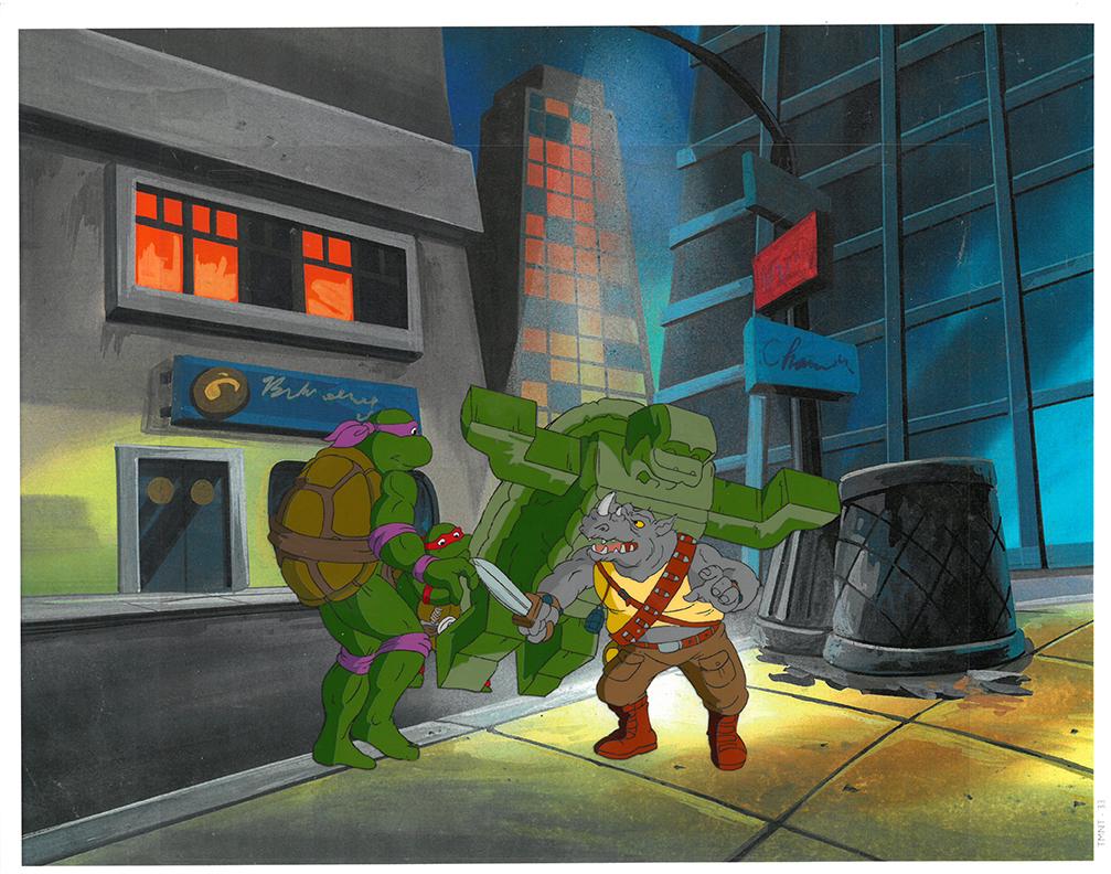 Rocksteady, Donatello and Raphael of (TMNT) Turtles-: An original Teenage Mutant Ninja Turtle production cel. This cel depicts a frame from a scene in a Teenage Mutant Ninja Turtles cartoon episode. This frame features Rocksteady, Donatello and Raphael .