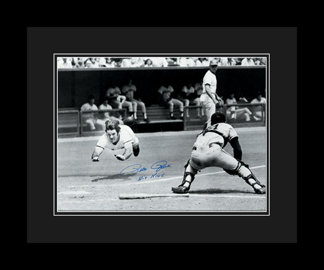 Pete Rose Diving Signed- Framed: This fuji crystal archival photograph captures the Pete Rose diving towards the plate. This photo was taken on July 30, 1972 and is autographed by Pete Rose. Pete played from 1963 to 1986, and is best