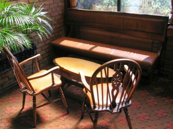 TABLE AND CHAIRS: Seating set comprising 2 x spindle "Goldilocks" wooden chairs, caramel leather padded bench with back rest and wooden "log" bar table