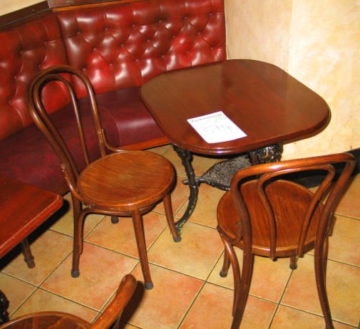 TABLE AND CHAIRS: Mahogany solid top dining table with cast iron base 780mm x 700 with 2 x spindle back wooden chairs