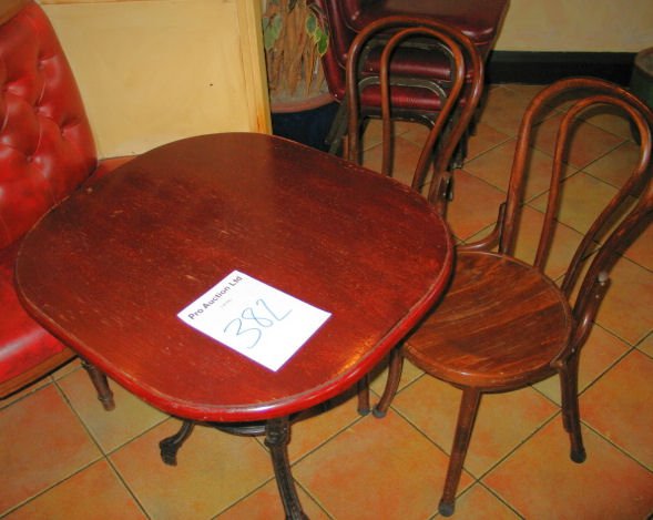 TABLE AND CHAIRS: Mahogany solid top dining table with cast iron base 780mm x 700 with 2 x spindle back wooden chairs